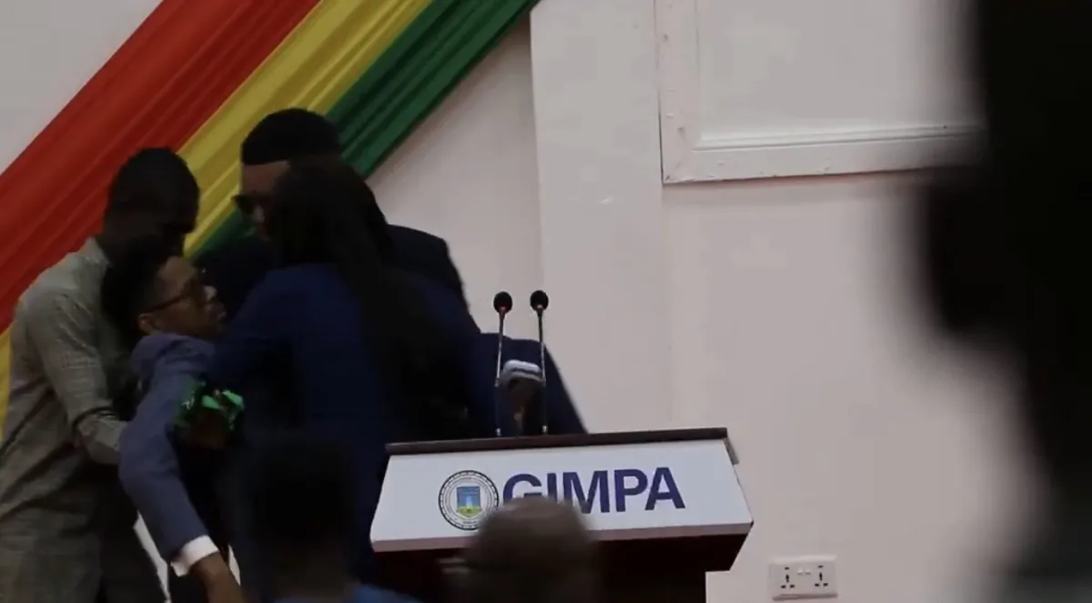 Francis-Xavier Sosu is assisted after reportedly collapsing while speaking at an event at GIMPA in Accra.